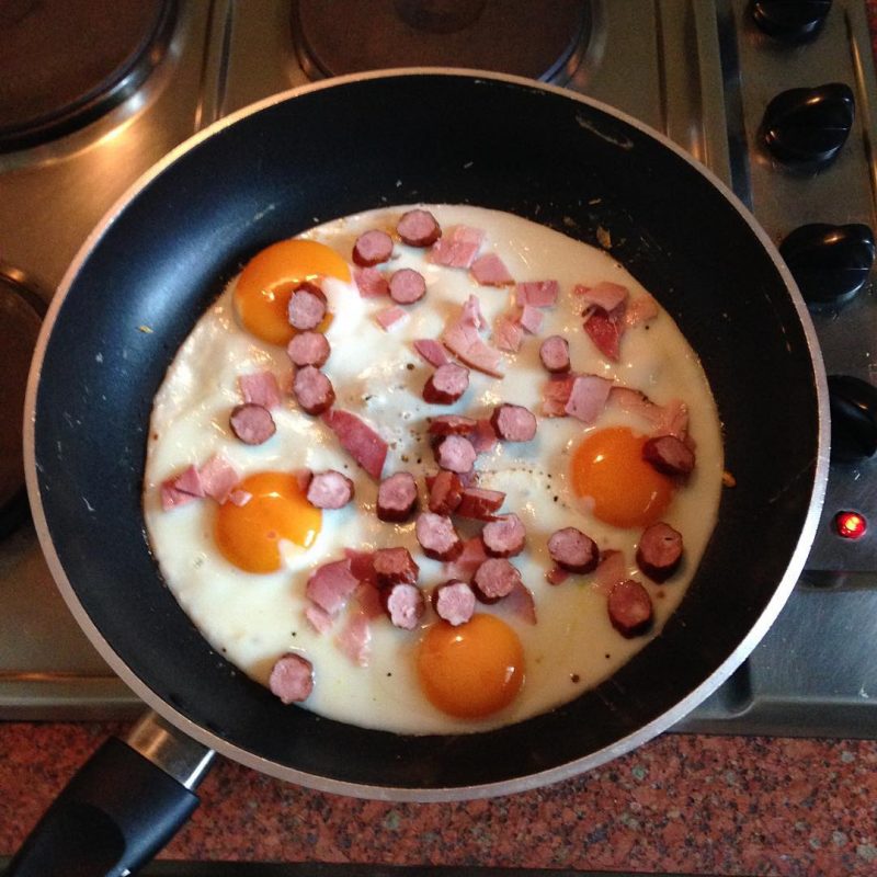 Fried eggs with smoked ham and Polish sausages