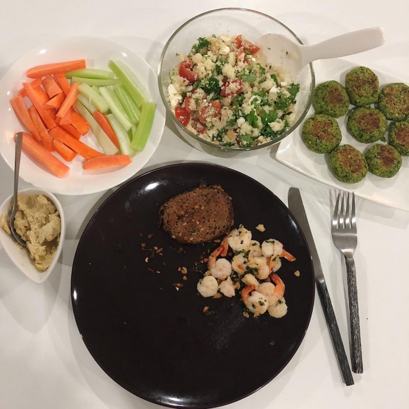 Gambas , dark bread, falafel, hummus, couscous salad dinner